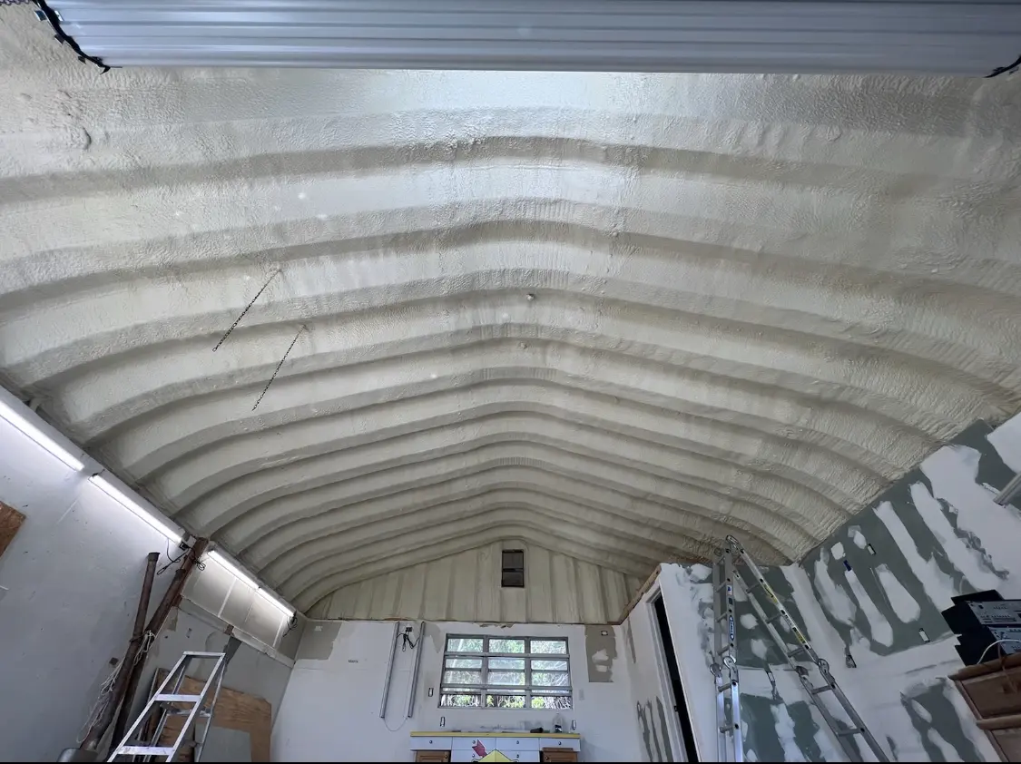 Spray polyurethane foam applied to the underside of a metal roof deck in East Alton